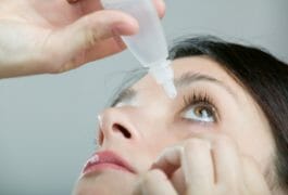 girl using eye drops