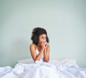 woman with cold in bed